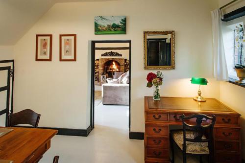 a room with a desk and a mirror and a bedroom at Breathtaking Elizabethan Manor House in Burnham on Crouch