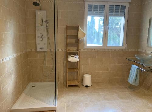 a bathroom with a shower with a glass door at Stunning 3 bedroom villa near Pinoso 