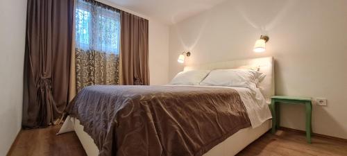 a bedroom with a large bed with a window at Apartments Boris in Poreč
