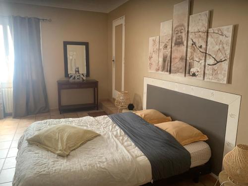 a bedroom with a large bed with two pillows at Bastide du Bonheur Saint Donat in Gréoux-les-Bains
