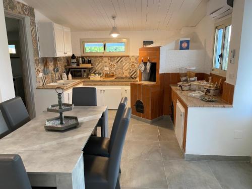 a kitchen with a large table and chairs in it at Villa Priscilla in Cinisi
