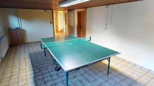 a ping pong table in a room with at Das kleine Familienhotel Koch in Eisentratten