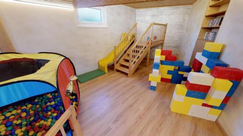 a room with a bunk bed and a staircase at Das kleine Familienhotel Koch in Eisentratten