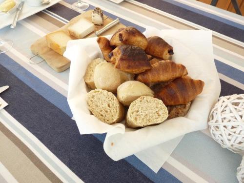 a tray of different types of bread on a table at LE CHALET de LA LONGERE in Beuvry-Nord