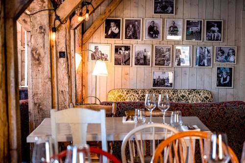 a restaurant with a table and chairs and pictures on the wall at Sakrisøy Rorbuer in Reine
