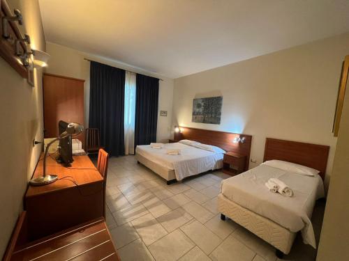 Postel nebo postele na pokoji v ubytování Hotel Adriatico