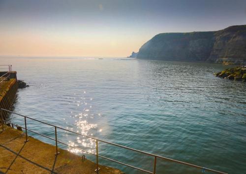 a view of a body of water with a cliff at The Anchorage your home in idyllic Staithes in Staithes