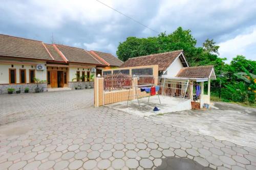 a house with a gate in front of it at Riverside Homestay Jogja in Yogyakarta
