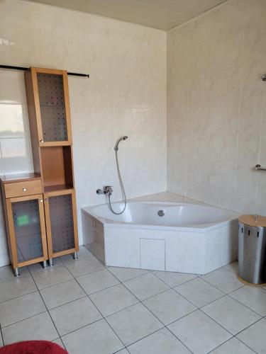 a large bathroom with a tub and a sink at Ferienhaus Vongerichten in Oberhausen