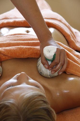 a man lying on the floor getting a massage at Hotel Bemelmans-Post in Collalbo