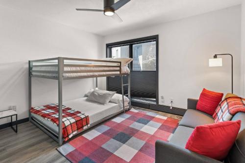 a bedroom with a bunk bed and a couch at Snowmass Modern 3 bedroom in Snowmass Village