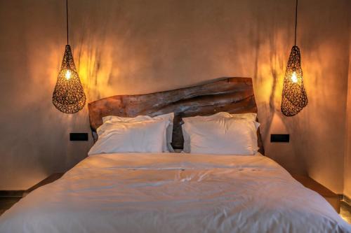 a bedroom with a large bed with two lights at Meteora Heaven and Earth premium suites - Adults Friendly in Kalabaka