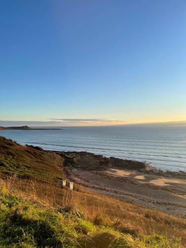 a beach with the ocean in the background at Beautiful 2-Bed Static caravan in Newton Stewart