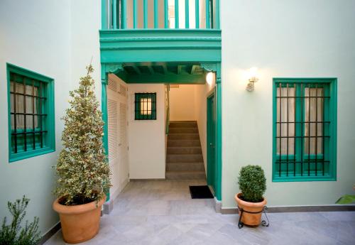 a house with a christmas tree in a hallway at Apartamentos Laurel Suites in Granada