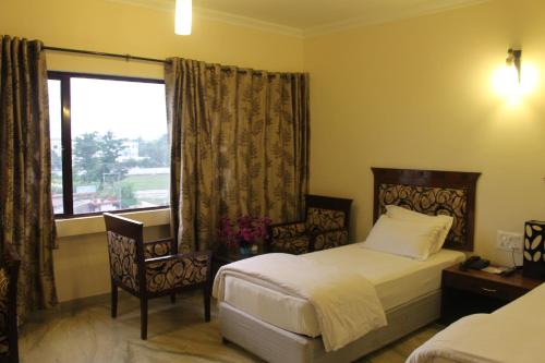 Кровать или кровати в номере Hotel Taj Darbar