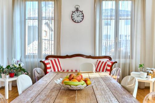 a dining room table with a bowl of fruit on it at Al Cavour 34 in Trento