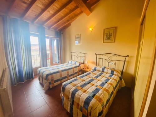 A bed or beds in a room at casa rural corral del Toro