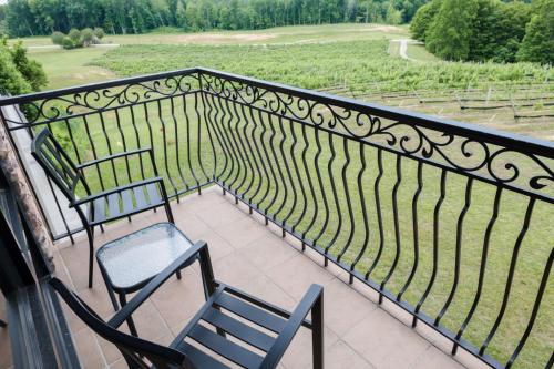 a balcony with chairs and a view of a field at Holiday Inn Express & Suites Lexington North West-The Vineyard by IHG in Lexington