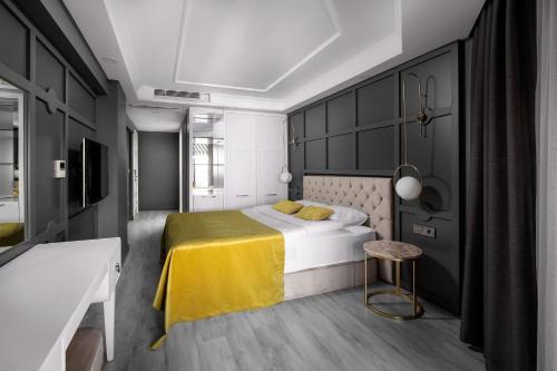 a bedroom with a bed with a yellow blanket at B LOFT HOTEL in Bursa