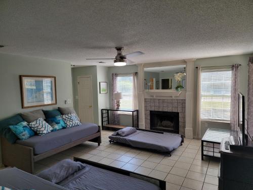 a living room with a couch and a fireplace at Five Minutes From the Beach in Navarre