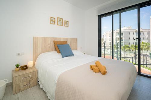 a bedroom with a large white bed and a large window at Valentino in Orihuela Costa