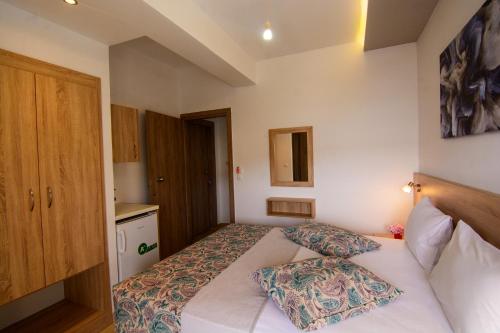 a bedroom with a bed with two pillows on it at Nicole Rooms in Palaiochóra