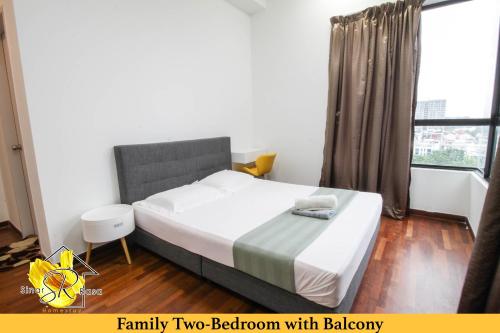 a bedroom with a large bed and a window at I-City Homestay@5 min walk to shopping Mall in Shah Alam