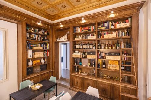 a dining room with a table and bookshelves at Fourooms - Bari Sparano in Bari