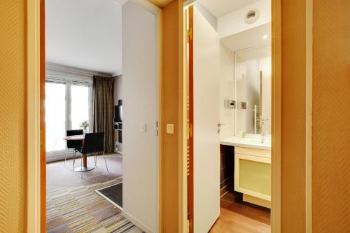 a bathroom with a sink and a mirror at CMG - Cosy & charmant appartement Paris in Issy-les-Moulineaux