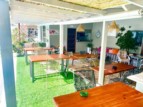 a group of tables and chairs in a restaurant at Attalos Apartments in Agia Pelagia
