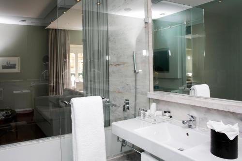 a bathroom with a sink and a mirror at Pousada de Lisboa - Small Luxury Hotels Of The World in Lisbon