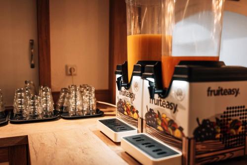 a blender on a counter with a bunch of drinks at Hotel Gorch Fock in Timmendorfer Strand
