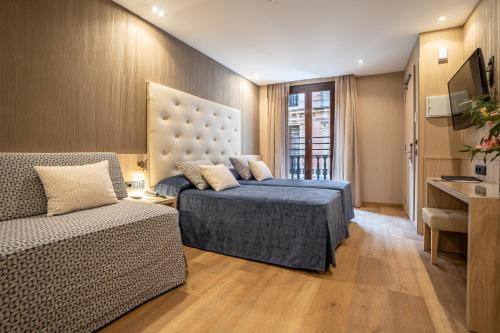 Un pat sau paturi într-o cameră la Hotel Rialto