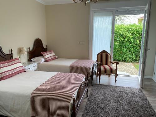 A bed or beds in a room at Casa Otilia - Rural - Camino de Santiago - Arzúa