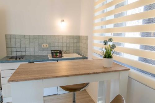 a kitchen with a table and a sink and a tub at Ferienanlage Zum Knirk in Lubmin
