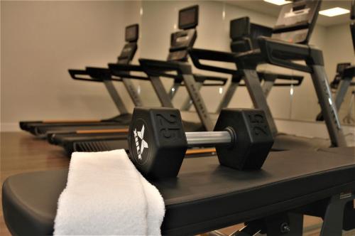 a row of exercise machines in a gym at Holiday Inn Express & Suites - Edmonton SW – Windermere by IHG in Edmonton