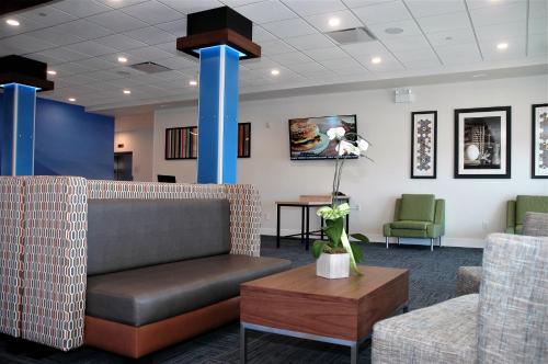 a waiting room with a couch and chairs at Holiday Inn Express & Suites - Edmonton SW – Windermere by IHG in Edmonton