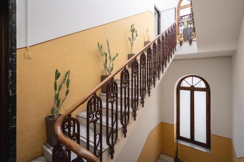 a staircase in a home with yellow and white walls at Fourooms - Bari Sparano in Bari