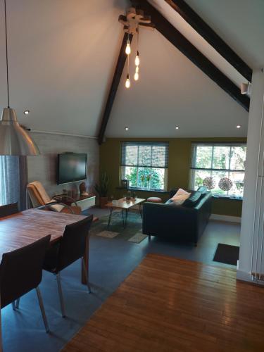 a living room with a table and a couch at Holiday Home Canal View in Alkmaar