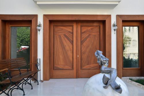 a statue of a snake in front of a wooden door at Arnna Hotel in Kas