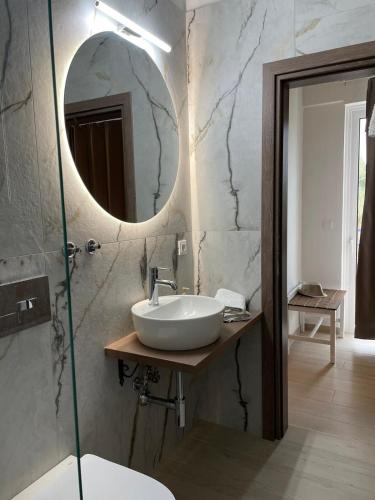 a bathroom with a sink and a mirror at Gennadi Beach Apartments in Gennadi