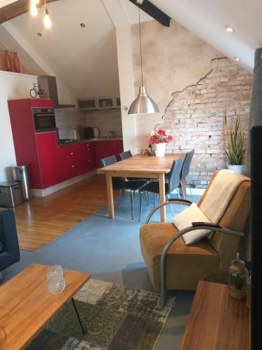 a living room with a table and a brick wall at Holiday Home Canal View in Alkmaar