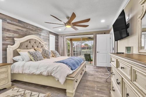 a bedroom with a bed and a ceiling fan at Fleming Ct Pool Home - Palm Coast in Palm Coast
