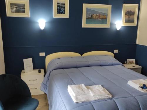 a blue bedroom with a bed and a chair at Il Viaggio di Dante Historical Center in Naples