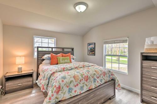 a bedroom with a bed and two windows at Bright Columbia Home 47 Mi to Dtwn Nashville in Columbia