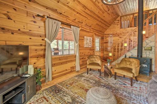 a log home living room with a fireplace and a tv at Large Deck, Grill Pet-Friendly Show Low Retreat! in Show Low