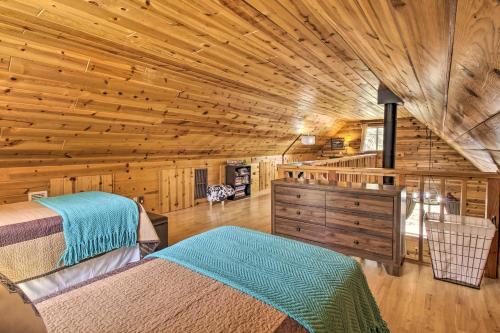a bedroom with two beds in a log cabin at Large Deck, Grill Pet-Friendly Show Low Retreat! in Show Low