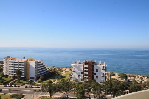 a view of two buildings and the ocean at Praia_da_Rocha_Vista_Mar/Ocean_View in Portimão