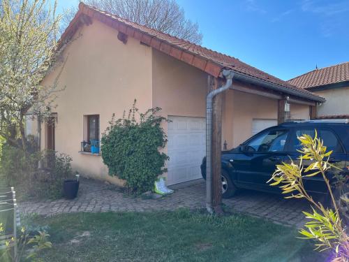 a car parked in front of a house at MIRABELLE in Chieulles