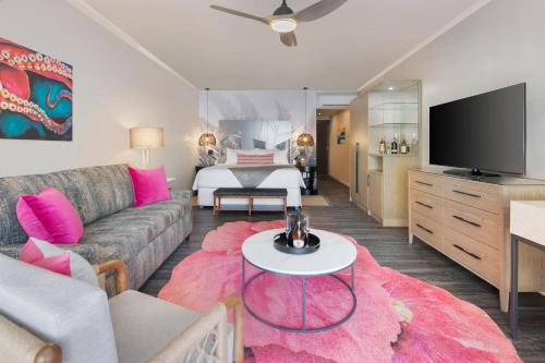 a living room with a couch and a tv at O2 Beach Club & Spa All Inclusive by Ocean Hotels in Christ Church